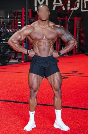 BODY BUILDER standing in gym