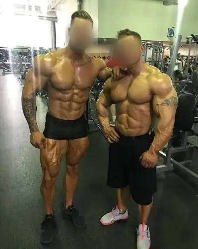 2 body builders standing in gym